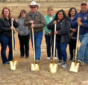 Image of people gathered with shovels for a ground breaking