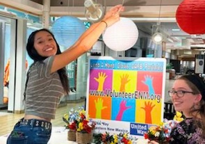 Photo of a volunteer helping set up lanterns