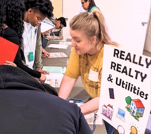 Photo of a volunteer helping students during Reality Check Day 